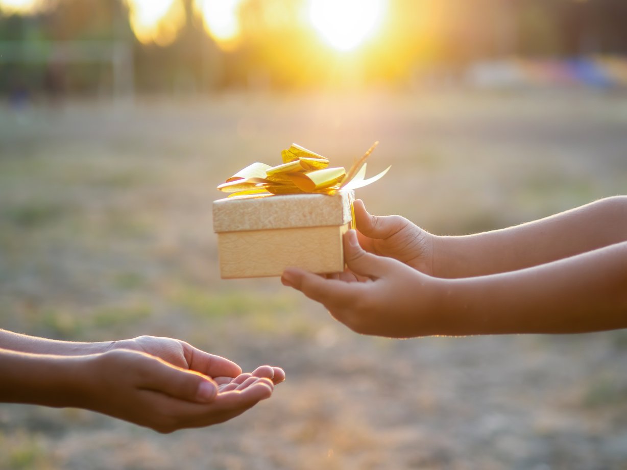 Kid Giving a Gift Box to Another Kid Up Close